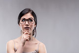Attractive woman in glasses deep in thought
