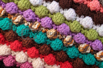 Multi-coloured crochet bobble stitches diagonal stripes backgrou