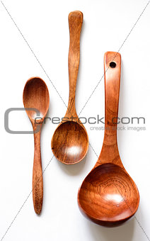 Three wooden spoon on a white background