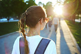 portrait of a young attractive woman with city backpack