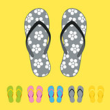 Row of colorful beach flip flops over color background
