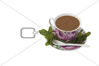 Cup of coffee on a saucer with mint. 