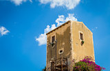 Sicily, Italy. Old house with purple flowers in Syracuse.