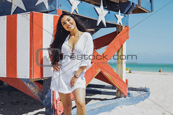 Content pretty woman posing confidently on beach