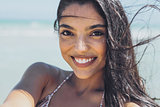 Charming ethnic woman on windy beach