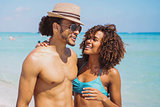 Couple standing and embracing at oceanside