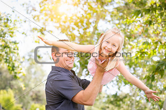 Young Caucasian Father and Daughter Having Fun At The Park