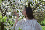 young girl in blooming trees