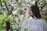 young girl in blooming trees