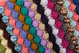 Bobble crochet stitches in diagonal stripes background texture