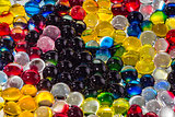 A horizontal texture of a group of multi-colored transparent hydrogel balls