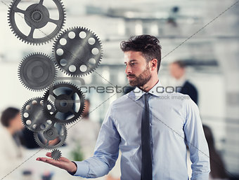 Businessman holds a gear system. Concept of business mechanism