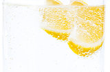 Two slices of fresh juicy lemon in lemonade.