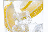 Slices of fresh juicy lemon into the cocktail with crystal clear water.