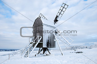 Snow covered traditional old windmill