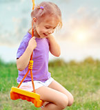 Cute baby girl on the swing