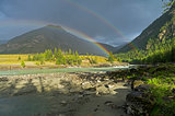 Rainbow over the river. Altai Mountains, Russia.