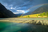 Rainbow over the river. Altai Mountains, Russia.