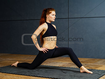 Beautiful redhead stretching her legs