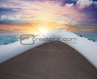 Inflatable boat at the sea during sunset