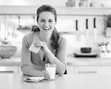 Smiling young woman having healthy breakfast