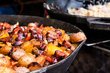 Pork sausages and Vegetables in pan. Tradition czech street food on market