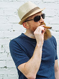 Bearded man smoking a cigar
