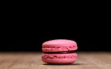 Pink macaroon on wooden background