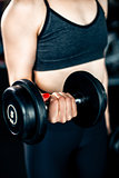 Girl doing bicep exercise with dumbbells
