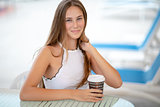 Beautiful woman drinking coffee outdoors