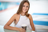 Beautiful woman drinking coffee outdoors