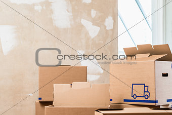 Heap of boxes in the interior of a residential room ready for renovation