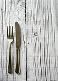 fork and knife on a white rustic wooden table