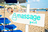 text massage point in a signpost on the beach
