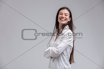Long-haired cheerful woman with arms crossed