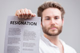 Man holding up a resignation letter