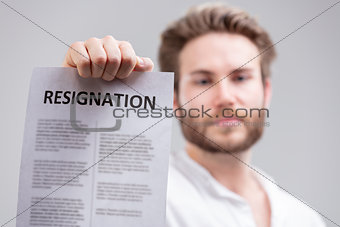 Man holding up a resignation letter