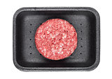 Raw fresh beef burger in plastic tray on white