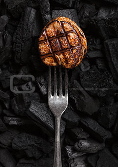 Grilled juicy beef pork steak on barbecue coil