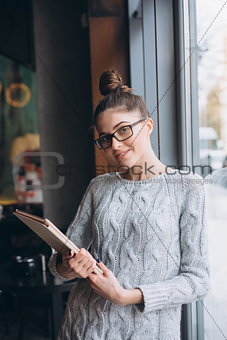 Asian woman using on tablet computer near window at cafe restaurant,