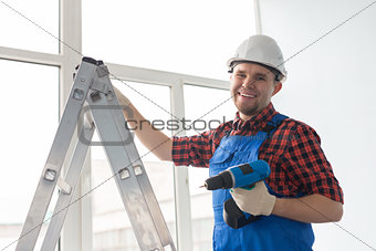 Man with screw gun or screwdriver, Building master, carpenter working with drilling machine