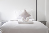 White fresh towel on single bed in bedroom 