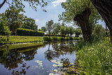 Picturesque Dutch landscape with a calm river surface on a summer day in a blue sky in the Netherlands