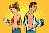 man and woman with dumbbells