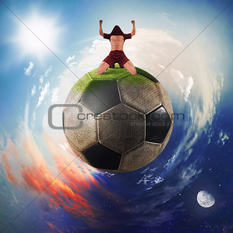 Football player exults in a soccer ball planet