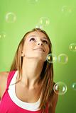 happy woman with flying soap bubbles