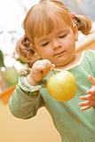 Girl playing with apple