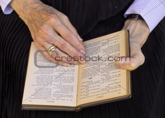 Grandmother reading in an old book of psalms