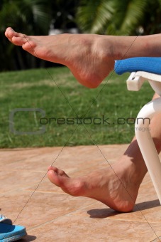 Woman feet resting on the chair