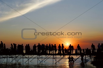 young people meeting sunset on sky background